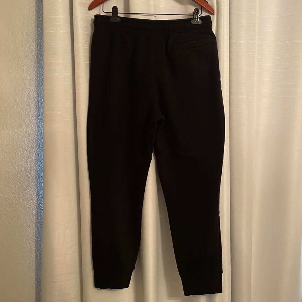 Reebok Sweats.  2 hand pockets, 1 back pocket and 1 side zipper pocket.